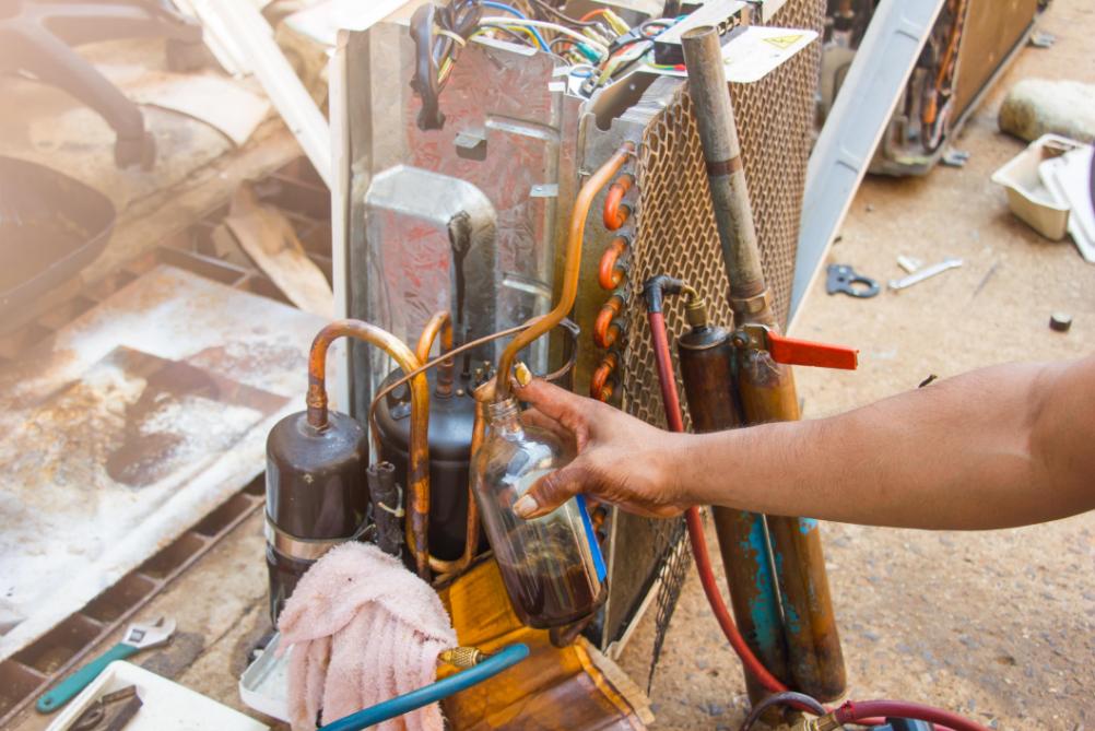 HVAC technician working on AC components