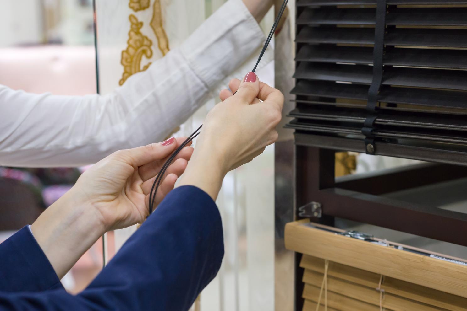 Technician adjusting window blinds and ventilation